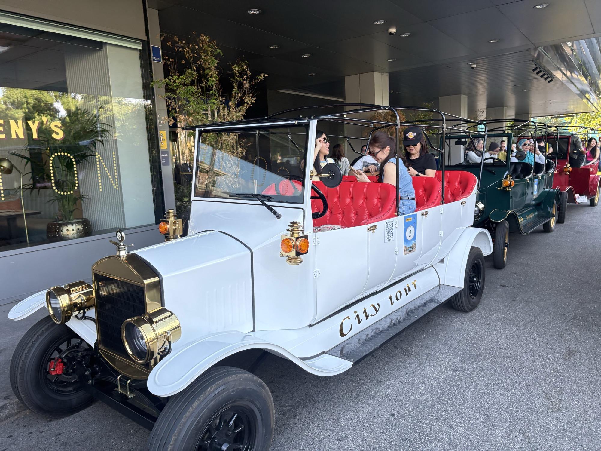 White vintage electric tour vehicle with red seats