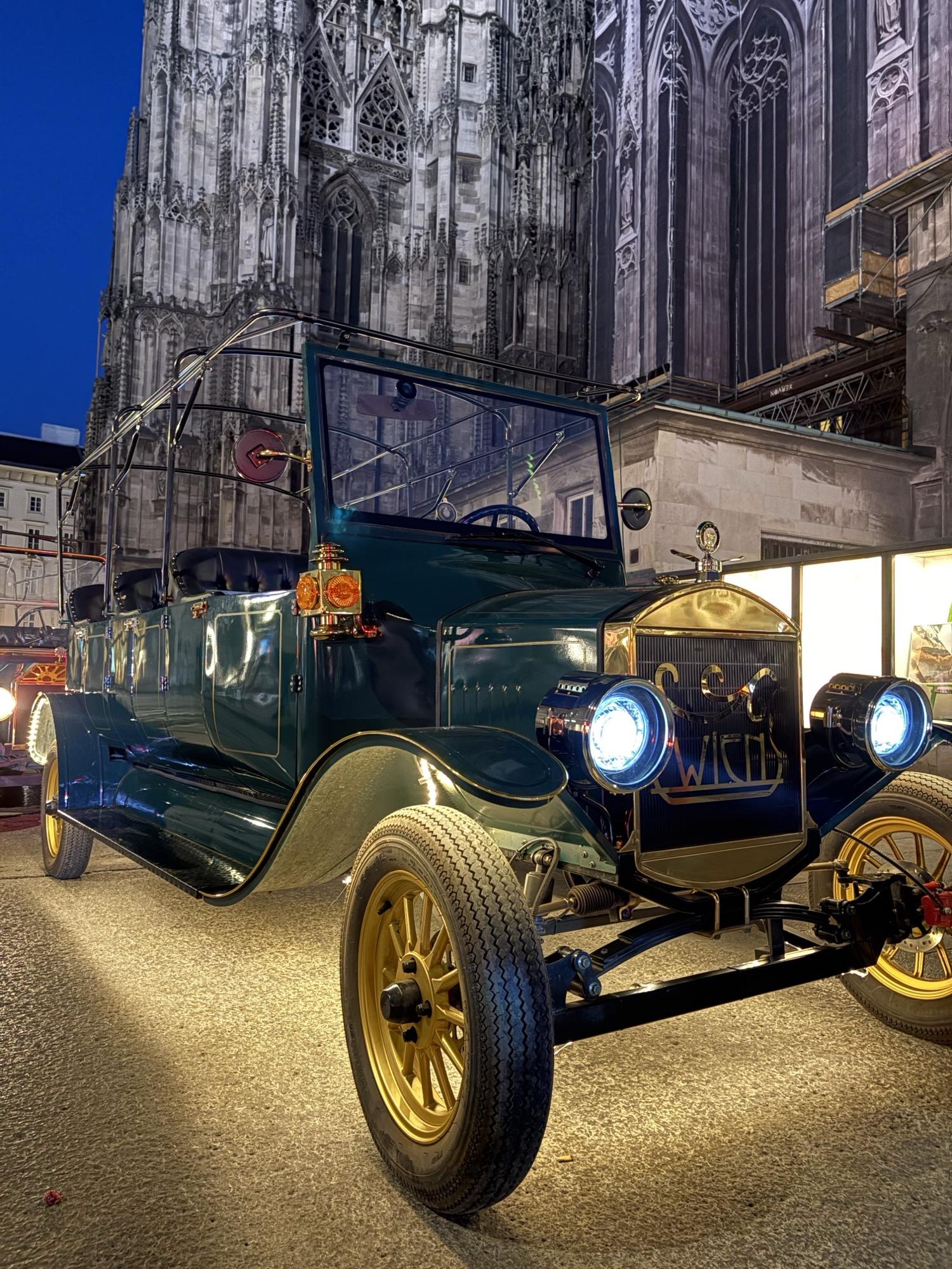 Dark green vintage EV at St. Stephen’s Cathedral at dusk
