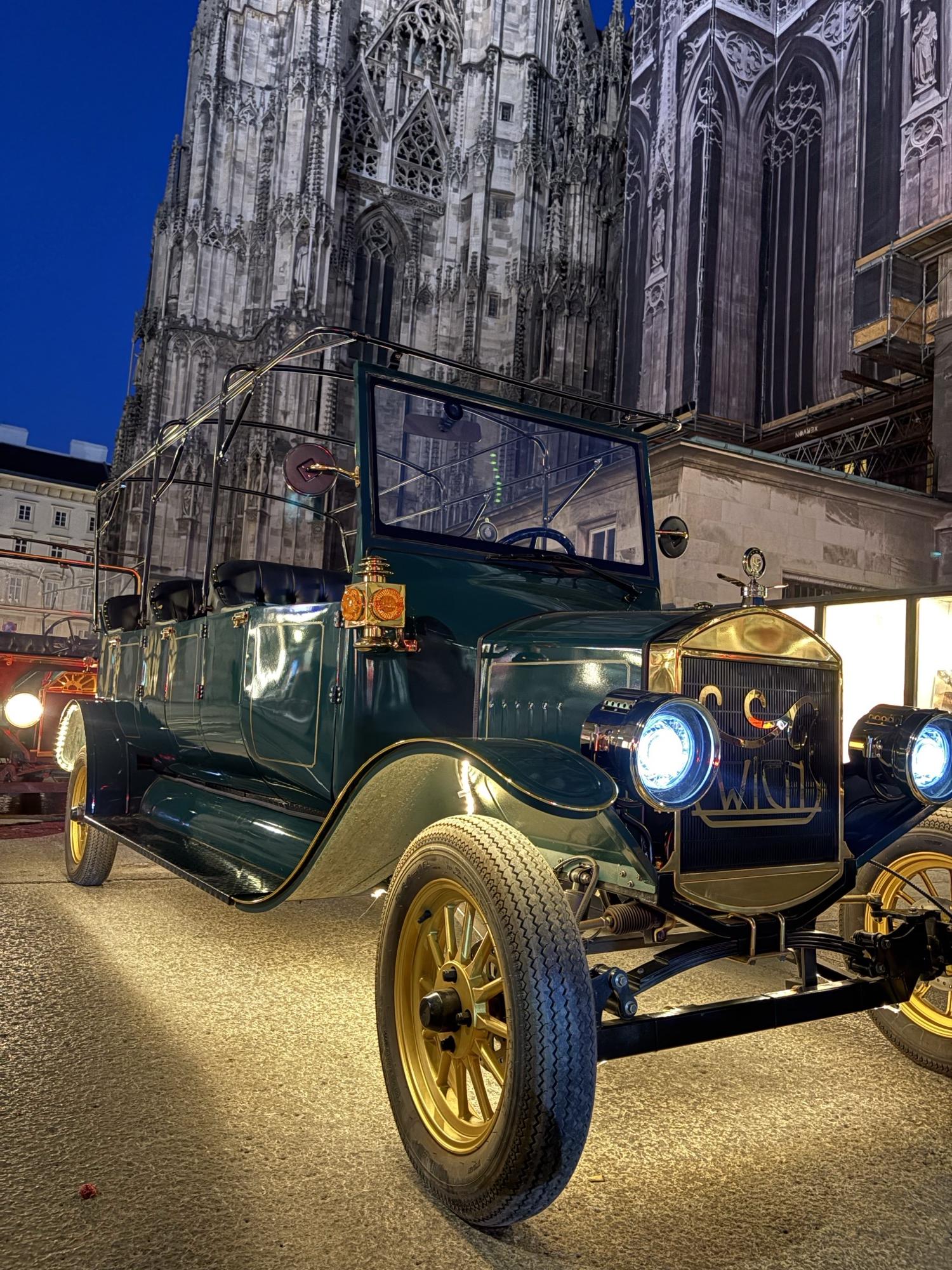Dark green vintage EV at Stephansdom at dusk